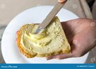 spread-butter-bread-close-up-man-putting-knife-slice-188522078.jpg