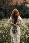 free-photo-of-woman-in-white-dress-holding-flowers-in-hands.jpeg