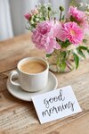 cup-coffee-sits-wooden-table-alongside-handwritten-good-morning-note-vase-pink-flowers-creatin...jpg