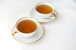 two-cups-tea-black-tea-porcelain-beautiful-white-cup-with-gold-cut-beautiful-sunshine-tea-cere...jpg