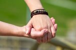 two-people-holding-hands-showing-love-and-connection-close-up-view-photo.jpeg