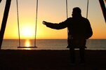 back-view-backlighting-silhouette-man-sitting-swing-alone-missing-her-partner-sunset-beach-win...jpg