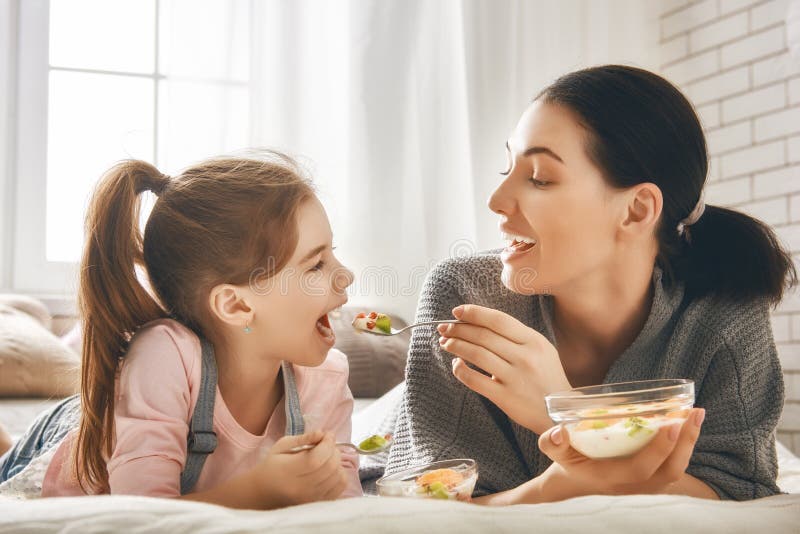 Mother And Daughter Eating Fruit Salad Stock Image - Image of ...