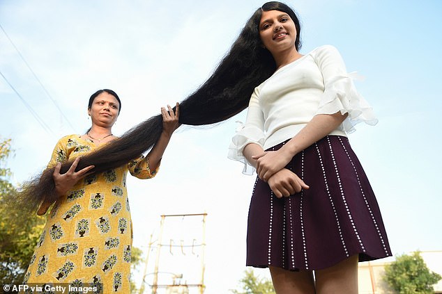 Nilanshi said she cares for her hair like every other teenager - but with help from her mother Kaminibenat (pictured)